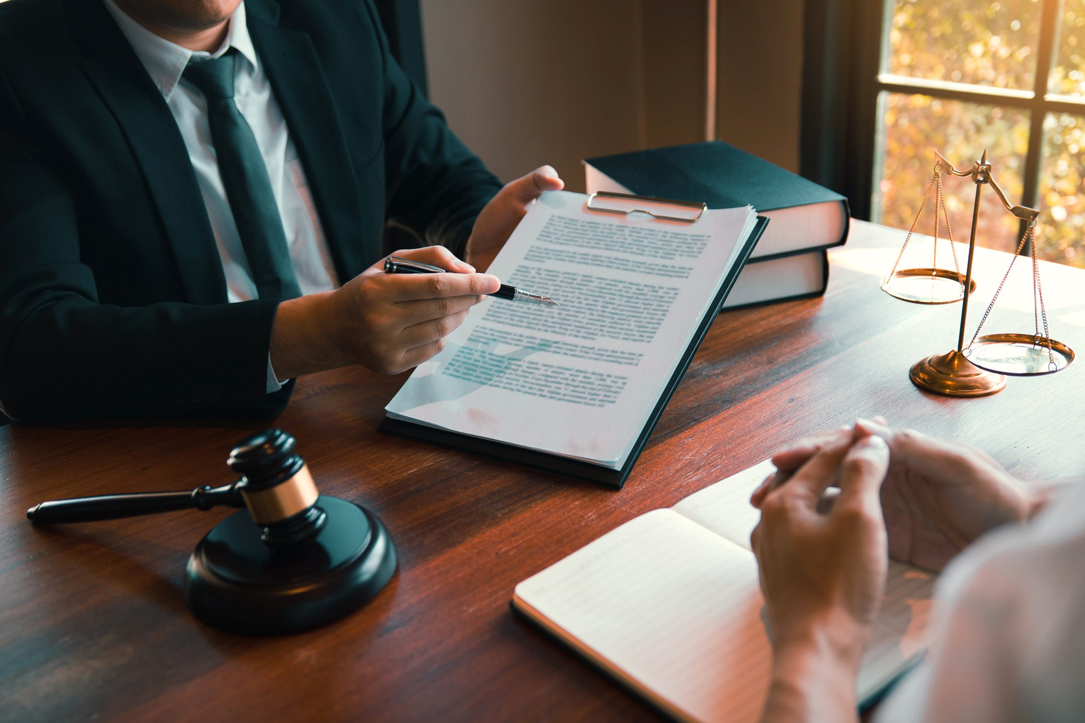 Lawyer discussing legal document with client.