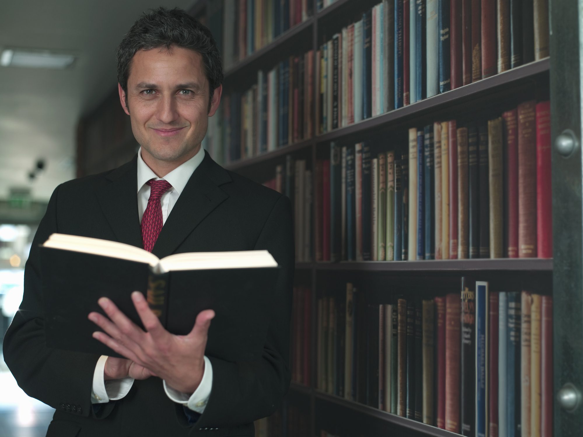 Man reading a book in library.